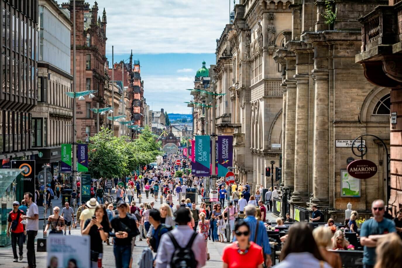 Busy UK high street with shoppers and businesses